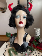 Load image into Gallery viewer, Mannequin head with black wig, red lipstick, and Krampus devil horns on a festive winter background.