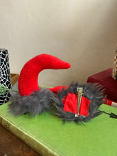 Load image into Gallery viewer, Mannequin head with black wig, red lipstick, and Krampus devil horns on a festive winter background.