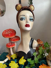 Load image into Gallery viewer, Mannequin head with bear ears surrounded by mushrooms and leaves