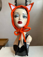 Load image into Gallery viewer, Mannequin head wearing an orange fox fleece headband with decorative mushrooms and plants in the background.