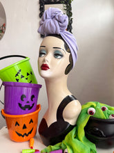 Load image into Gallery viewer, Mannequin head wearing lilac turban with Halloween-themed decorations 