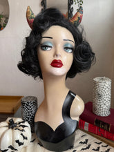 Load image into Gallery viewer, Mannequin head with black wig, red lipstick, and floral devil horns against a neutral background.