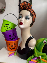 Load image into Gallery viewer, Mannequin head with Halloween-themed decorations including buckets and a witch hat.