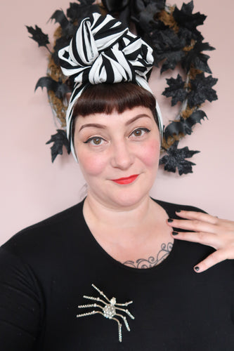women wears vintage style black and white striped halloween headband