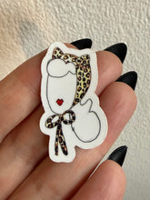 Load image into Gallery viewer, Sticker of a cat wearing a leopard print headscarf held between fingers against a neutral background