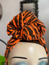 Load image into Gallery viewer, Orange and black tiger print patterned headscarf on a mannequin head against a neutral background