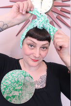Load image into Gallery viewer, Woman tying a green floral 1940s handmade vintage headscarf