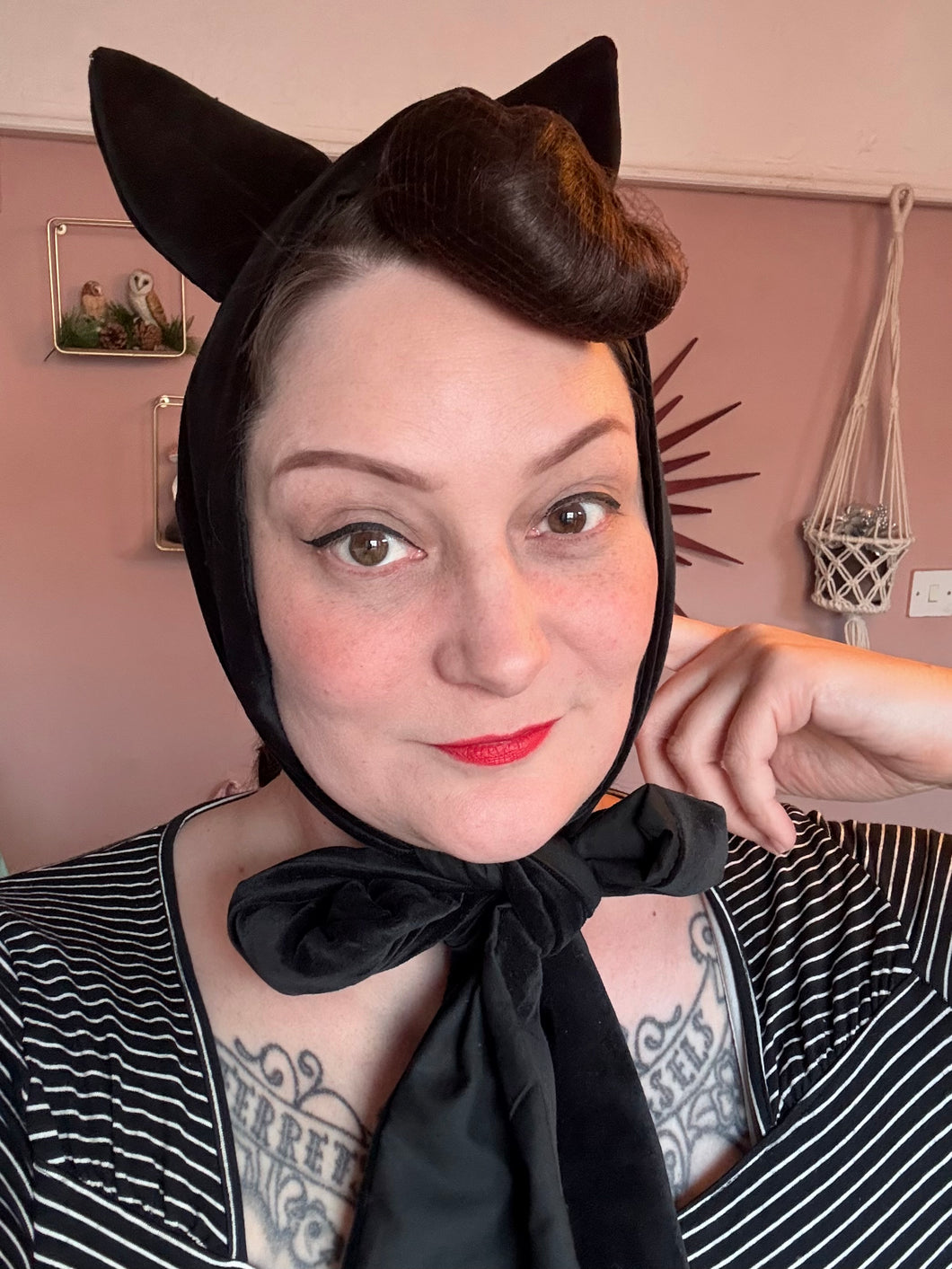 Woman wears a gothic black velvet cat ear headband 