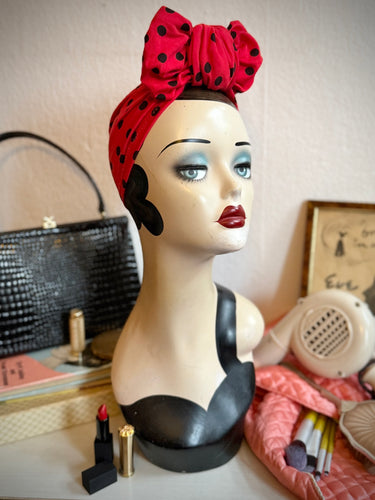 Display head wearing bright red polkadot vintage turban