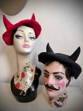Load image into Gallery viewer, Two mannequin heads with decorative tattoos wearing horned beret hats on a plain background