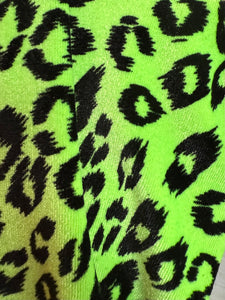 Neon green fabric with black leopard print pattern