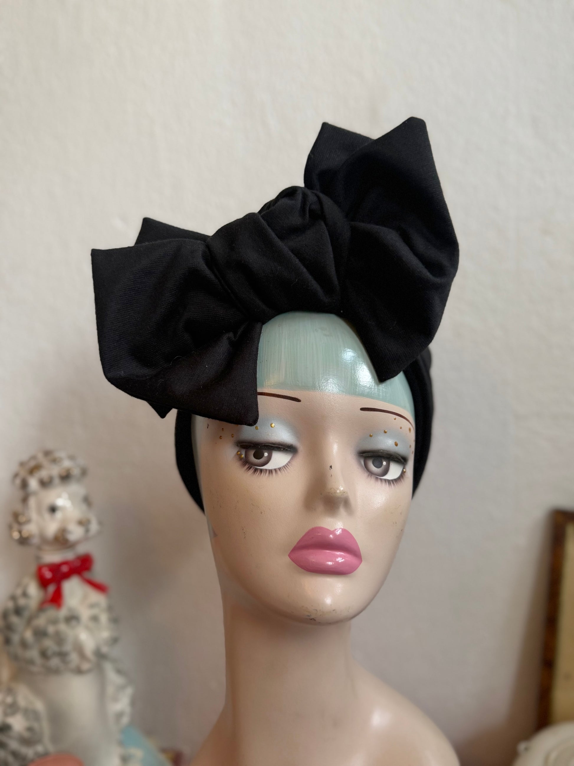 Vintage display head wearing a glamorous black 1940s inspired turban
