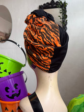 Load image into Gallery viewer, Mannequin head wearing a black and orange patterned headscarf with Halloween-themed buckets in the background.