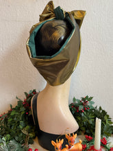 Load image into Gallery viewer, Mannequin head with gold headscarf, Christmas decorations, and deer figurines in background