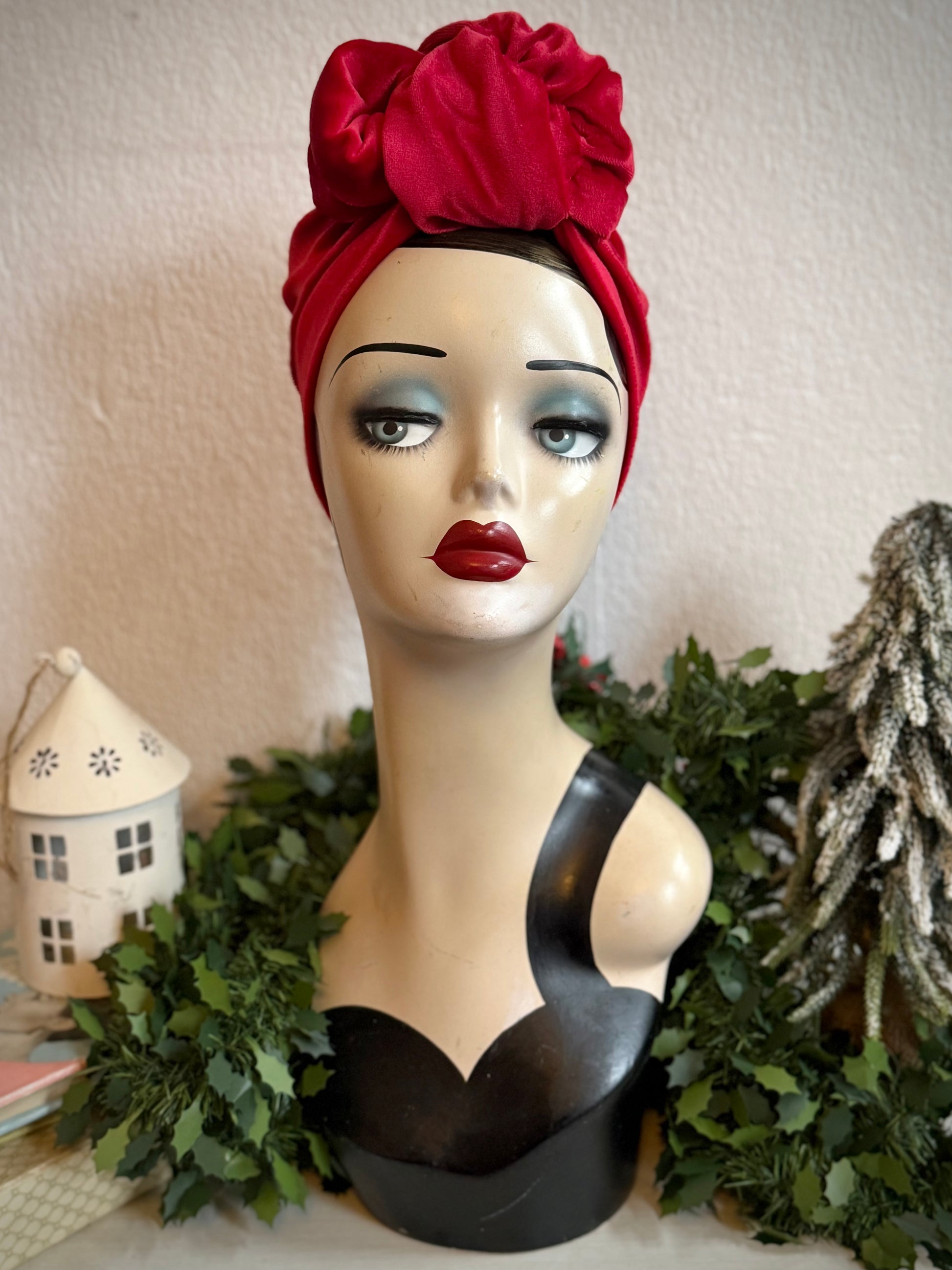 Mannequin head with a festive red velvet turban