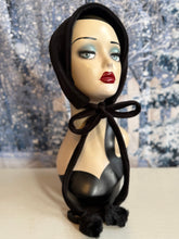 Load image into Gallery viewer, Mannequin head with black hood and makeup against a snowy background