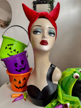 Load image into Gallery viewer, Mannequin head with red headband and Halloween-themed buckets and candy.