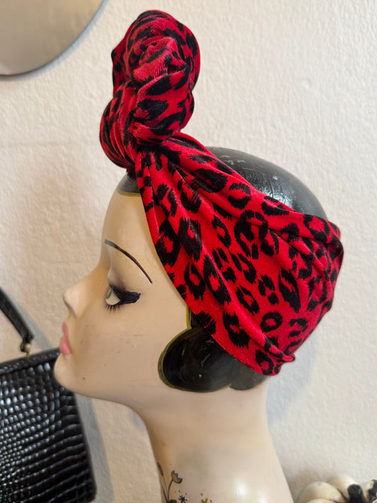 Red leopard print headband on a display head with tattoos 