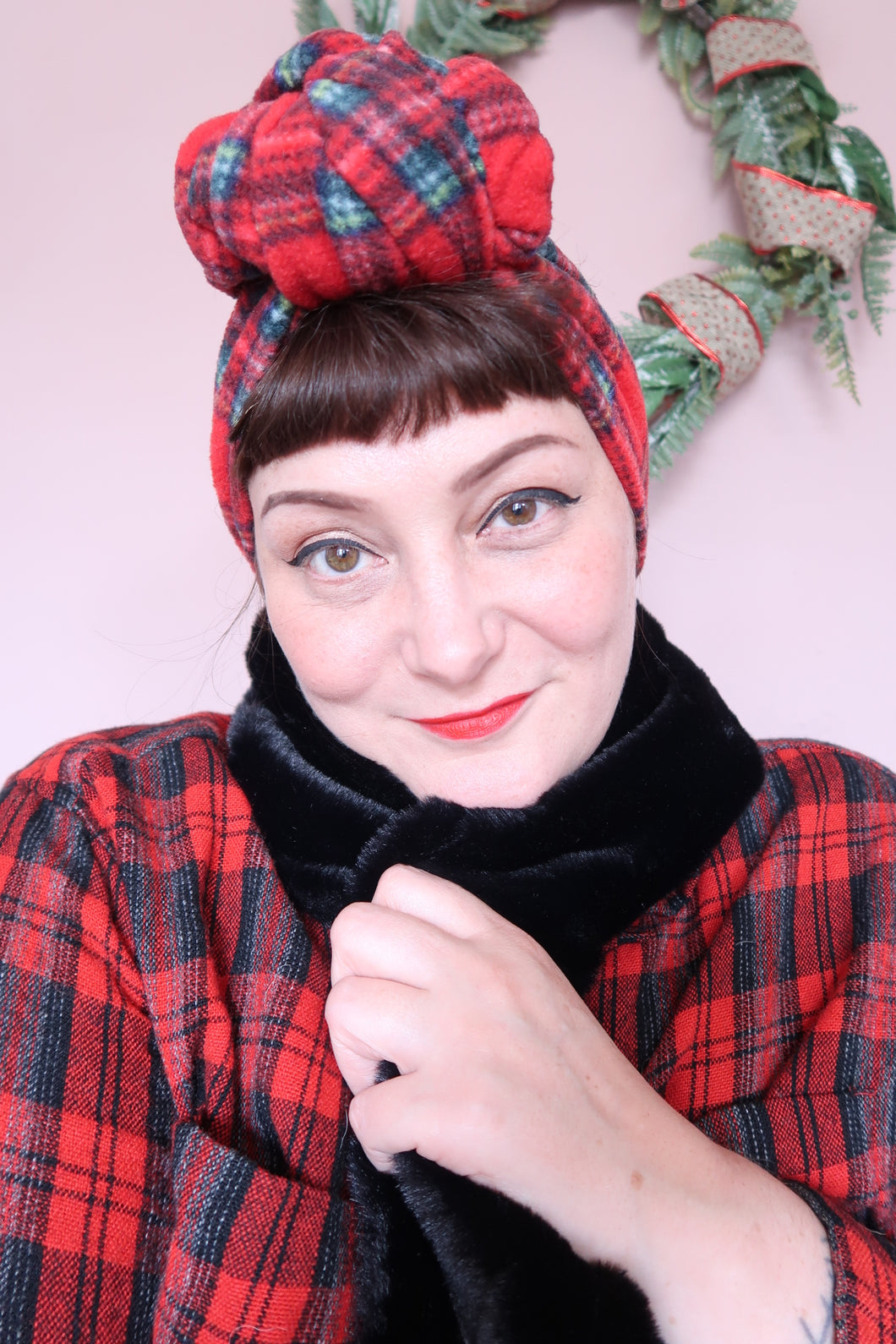 woman wears vintage tartan and faux fur scarf