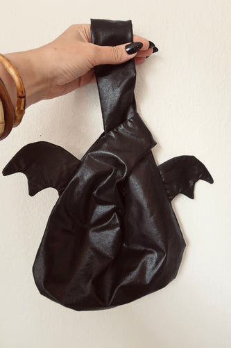 Black Halloween bay bag held on a hand with gothic nails