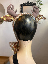 Load image into Gallery viewer, Mannequin head with deer antlers and a patterned scarf, surrounded by decorative mushrooms and leaves.