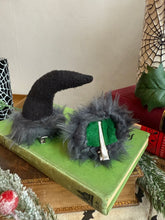 Load image into Gallery viewer, Mannequin head with black wig, red lipstick, and Krampus devil horns on a festive winter background.