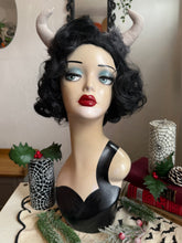 Load image into Gallery viewer, Mannequin head with black wig, red lipstick, and Krampus devil horns on a festive winter background.