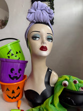 Load image into Gallery viewer, Mannequin head wearing lilac turban with Halloween-themed decorations 