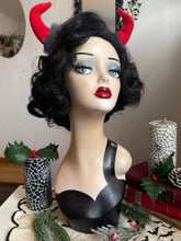 Load image into Gallery viewer, Mannequin head with black wig, red lipstick, and Krampus devil horns on a festive winter background.