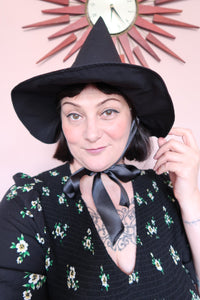 Woman wears vintage witch hat