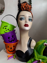 Load image into Gallery viewer, Mannequin head with Halloween-themed decorations including buckets and a green frog.