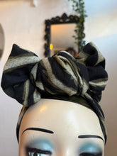 Load image into Gallery viewer, Black and gray striped headband on a mannequin head with makeup.