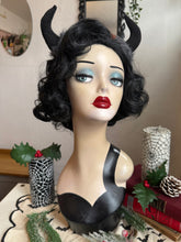 Load image into Gallery viewer, Mannequin head with black wig, red lipstick, and Krampus devil horns on a festive winter background.
