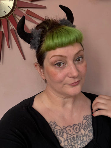 Woman wearing black devil horn hair clips 