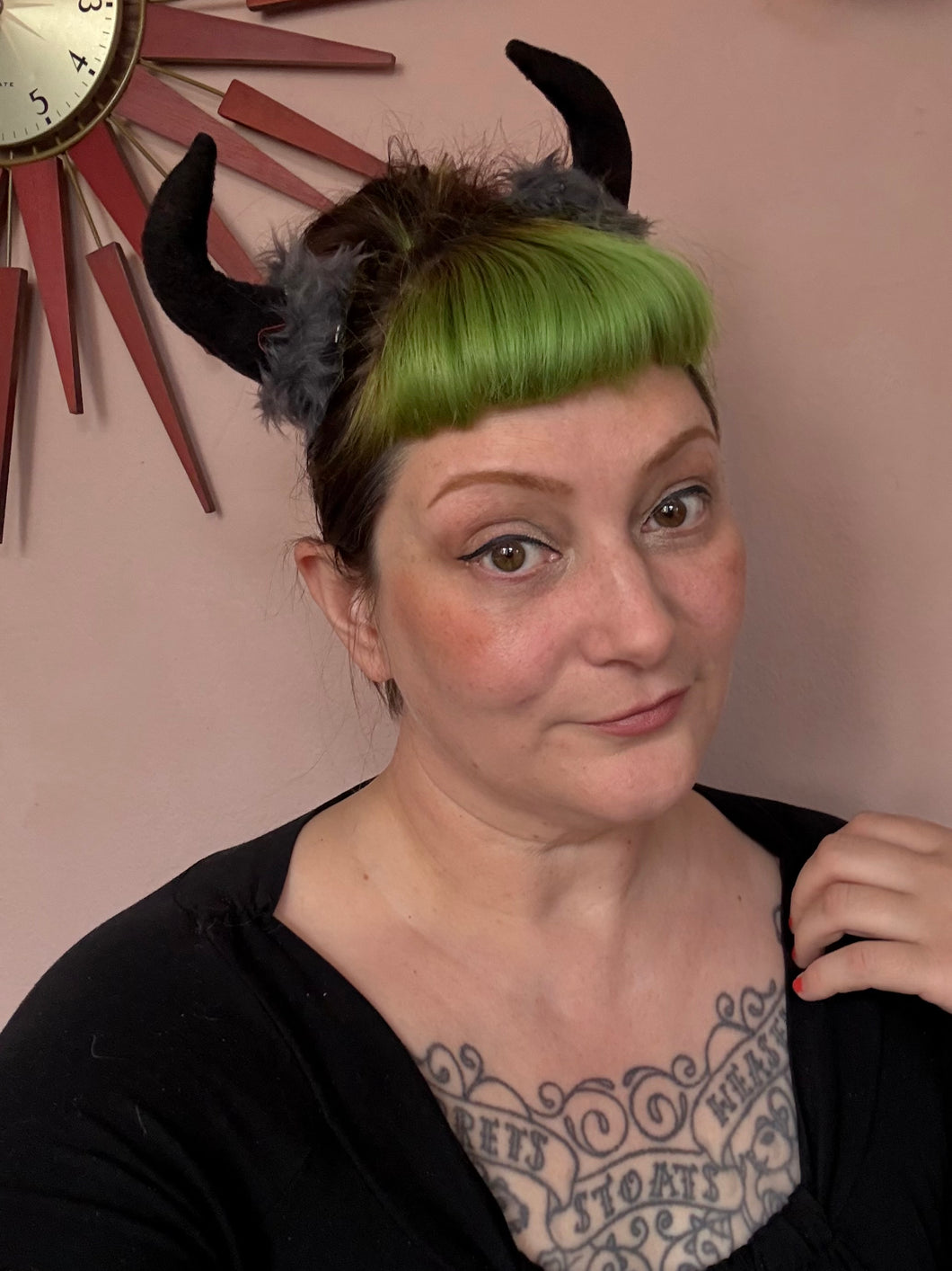 Woman wearing black devil horn hair clips 