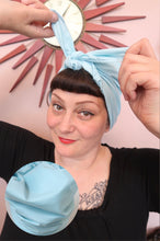 Load image into Gallery viewer, Woman tying a light blue 1940s handmade vintage headscarf