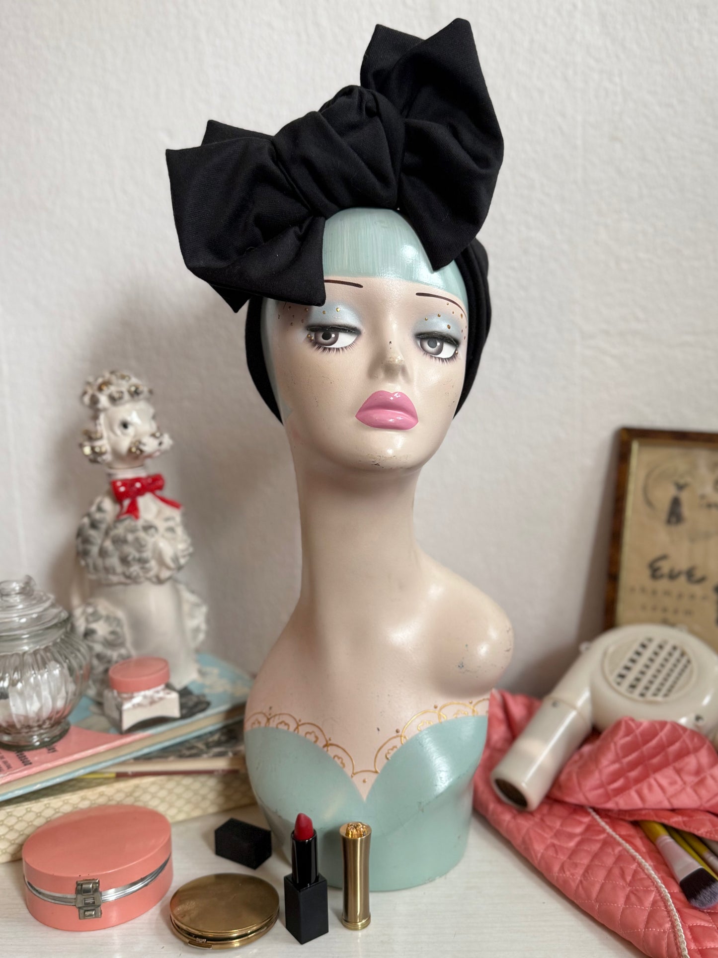 Glamorous handmade 1940s black vintage turban On a vintage dressing table background