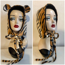 Load image into Gallery viewer, Tiger-striped hooded garment on a mannequin against a neutral background