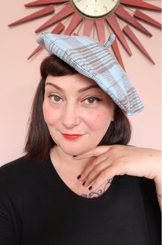 woman wears vintage plaid beret