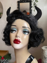 Load image into Gallery viewer, Mannequin head with black wig, red lipstick, and Krampus devil horns on a festive winter background.