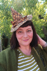 Woman wears brown witch hat